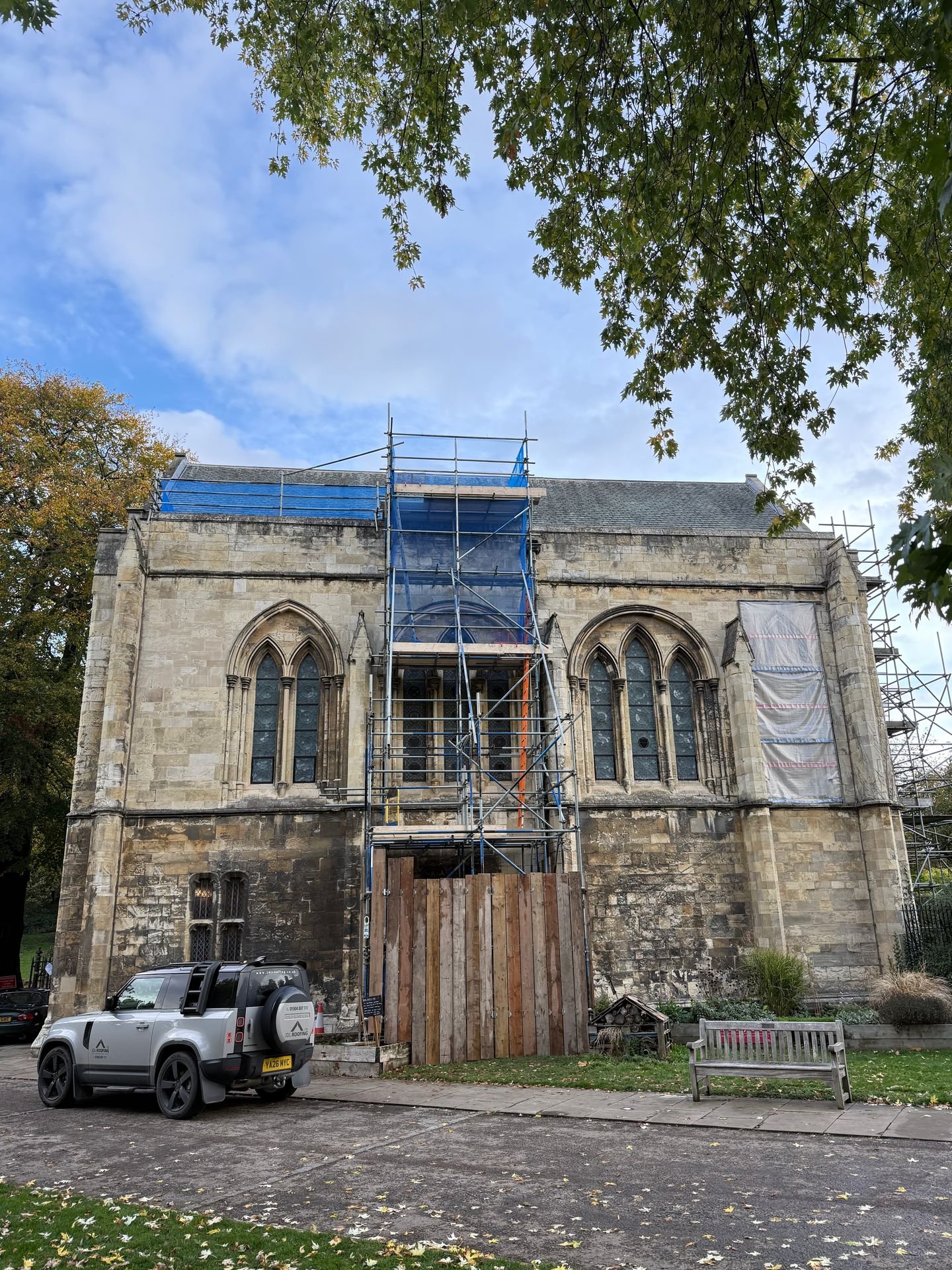 JDL Roofing vehicle outside a stone church